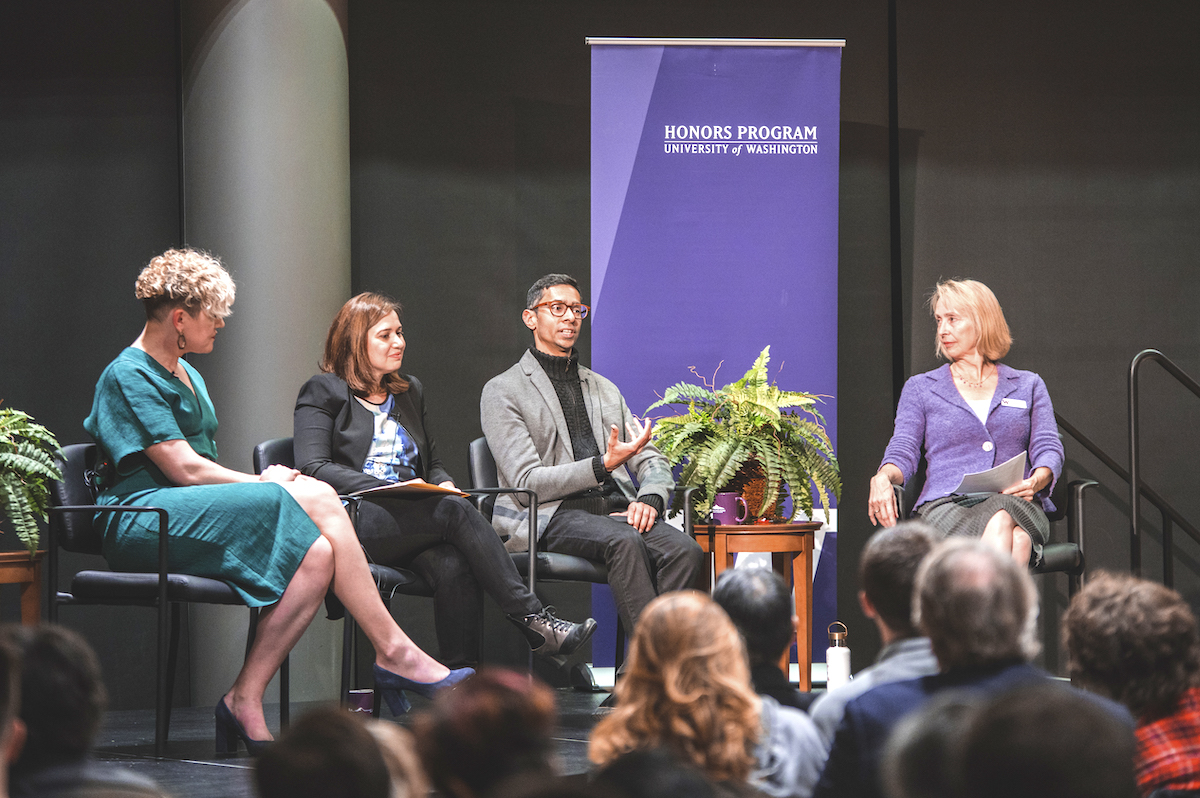Shankar Narayan makes a point, Vicky Lawson and other speakers listen closely