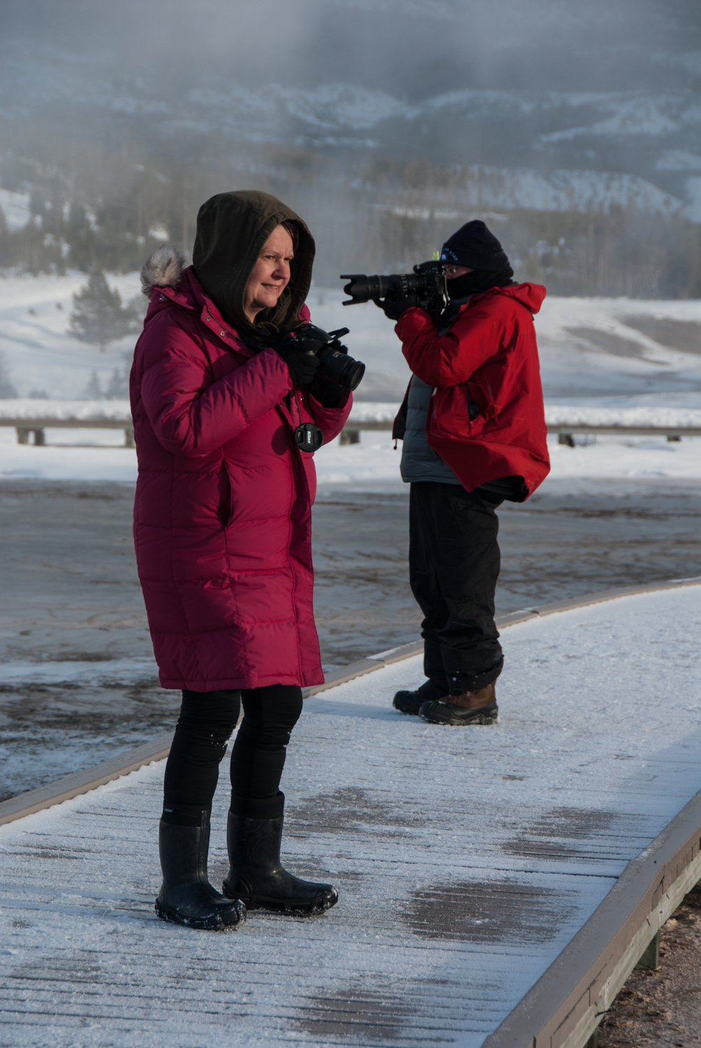 Sue Sherbrooke taking photos on a snowy trip to Yellowstone