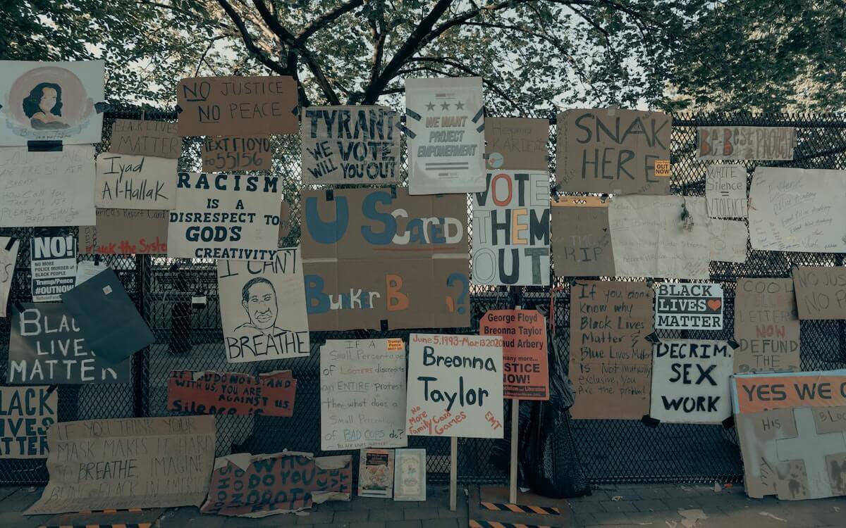Protest signs posted on the gate surrounding the White House