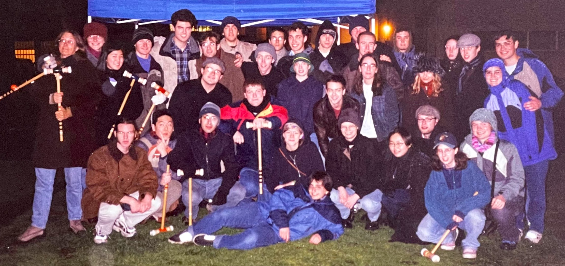 group of students holding croquet gear in winter outfits