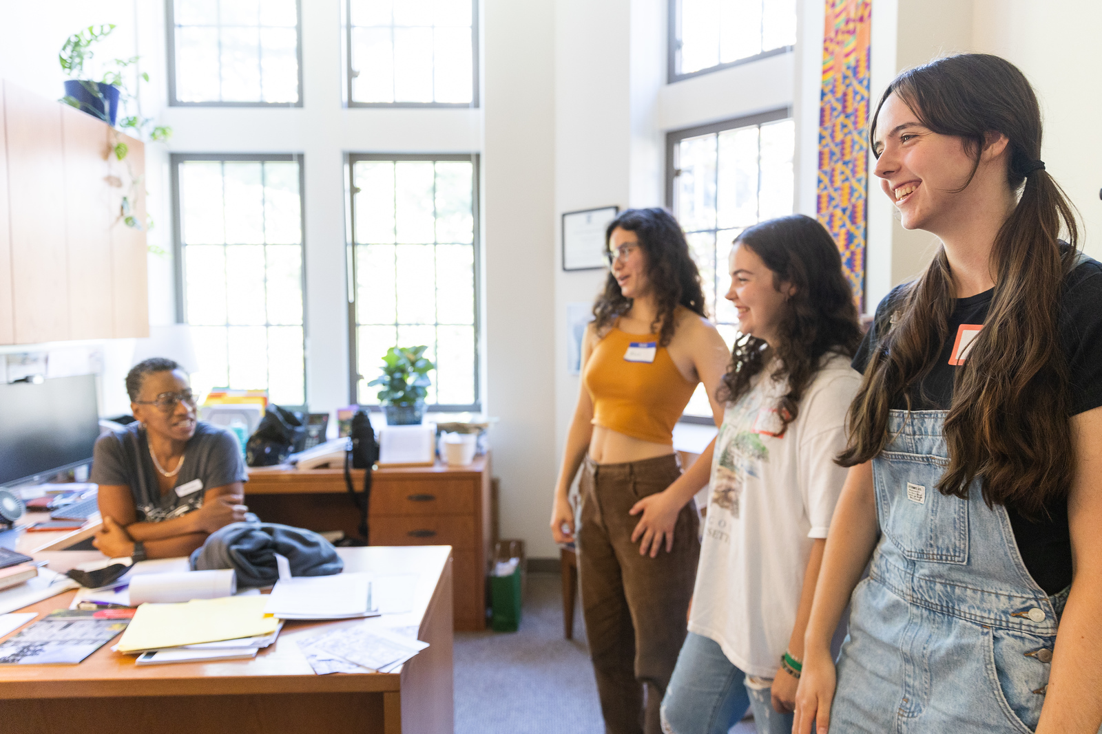 Stephanie Smallwood chats with new students in her office.