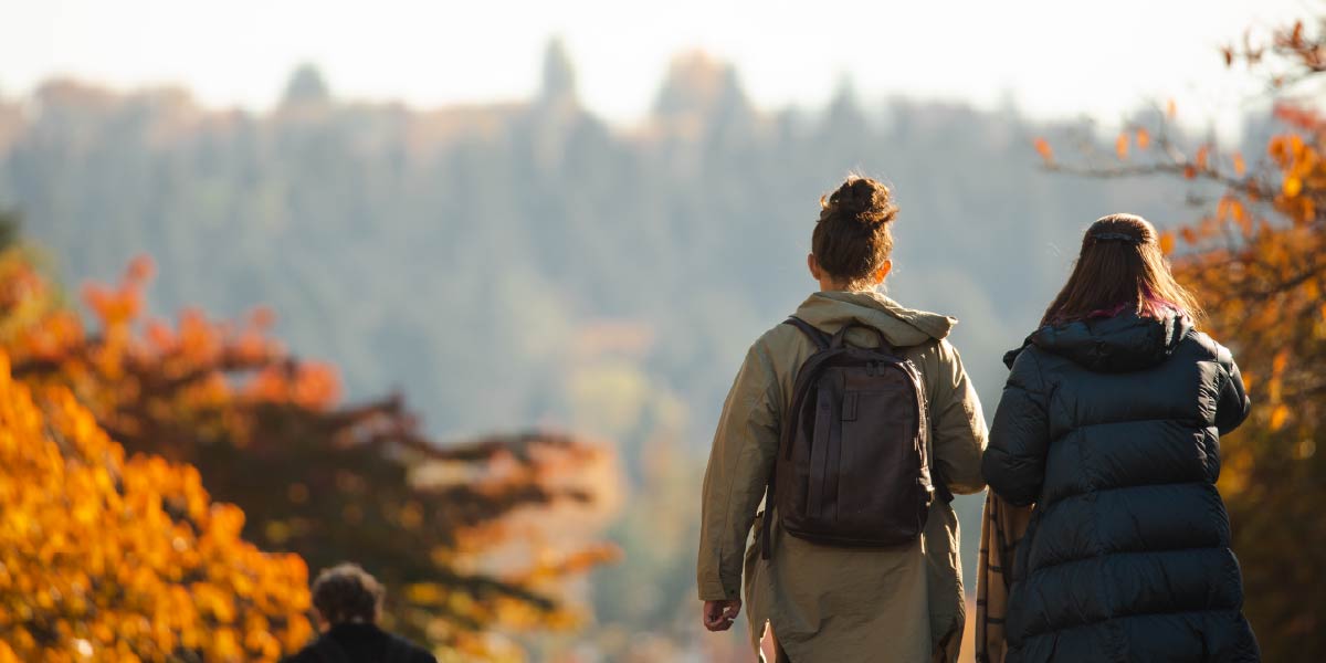 Two women walking on an autumn day.